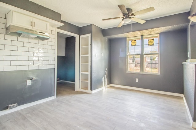 unfurnished bedroom with ceiling fan, a textured ceiling, and light wood-type flooring