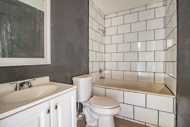 full bathroom with vanity, toilet, and tiled shower / bath combo