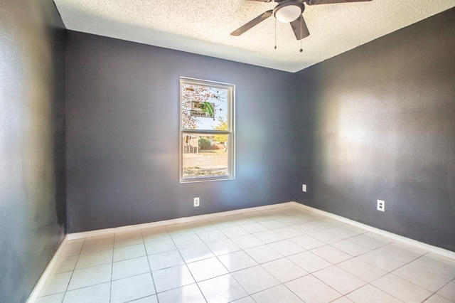 unfurnished room featuring light tile patterned flooring, a textured ceiling, and ceiling fan