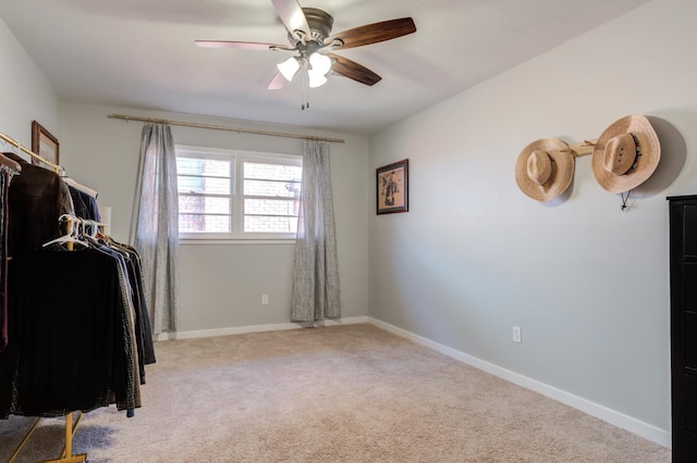 interior space with light colored carpet and ceiling fan