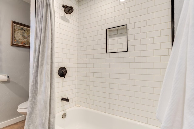 bathroom with shower / tub combo with curtain, wood-type flooring, and toilet