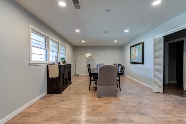 dining space with light hardwood / wood-style flooring