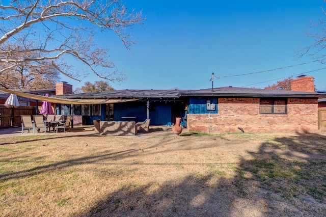 rear view of house featuring an outdoor living space, a lawn, and a patio area