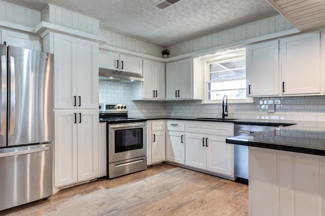 kitchen featuring stainless steel appliances, sink, and white cabinets