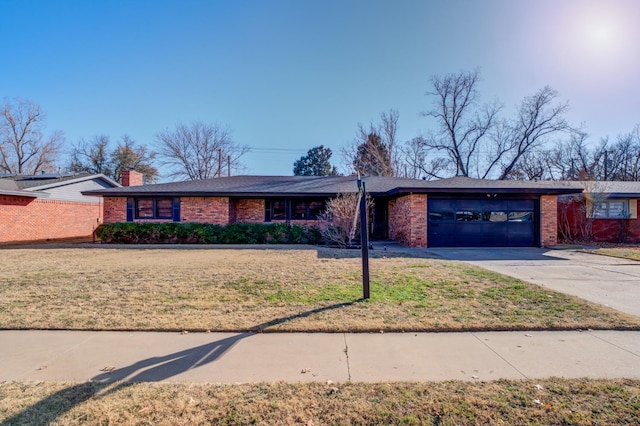 ranch-style house with a garage and a front lawn