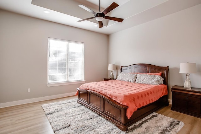 bedroom with ceiling fan and light hardwood / wood-style flooring