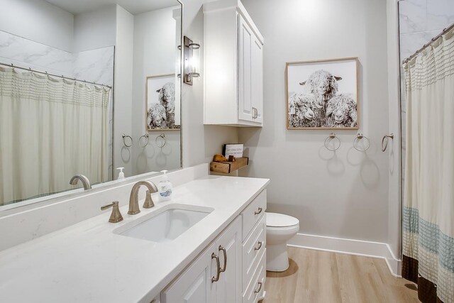 bathroom featuring vanity, hardwood / wood-style floors, toilet, and a shower with shower curtain