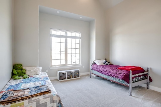 carpeted bedroom with vaulted ceiling