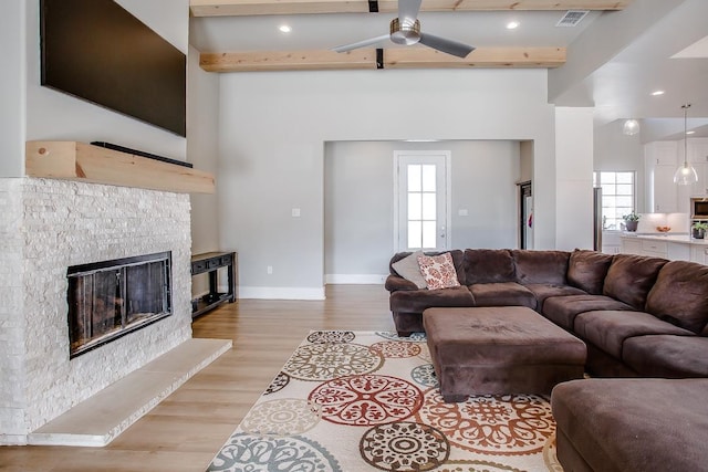 living room with light hardwood / wood-style flooring and ceiling fan