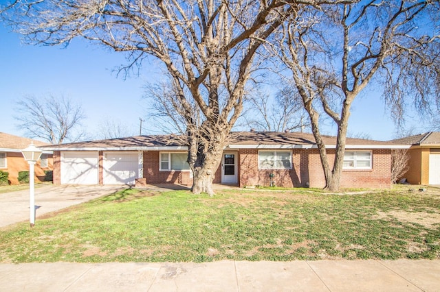 ranch-style house featuring a garage, a front yard, brick siding, and concrete driveway