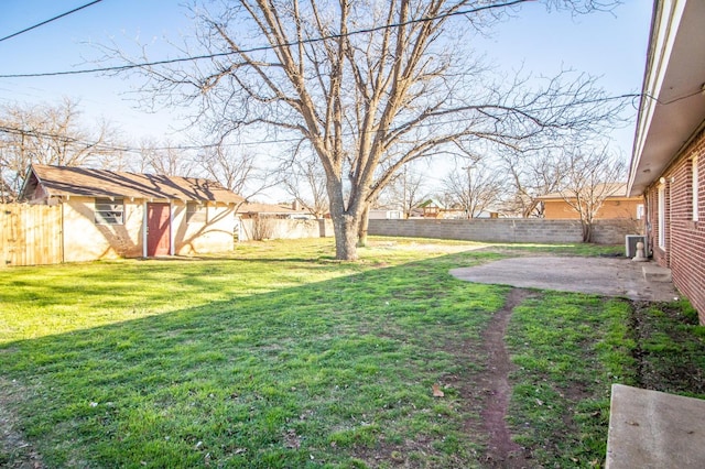 view of yard featuring a storage shed, a patio, a fenced backyard, and an outdoor structure