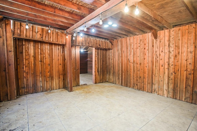 basement featuring wooden walls