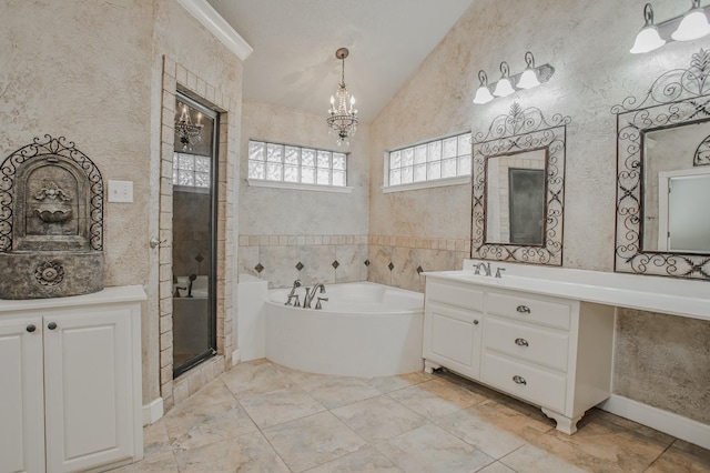 bathroom featuring an inviting chandelier, lofted ceiling, shower with separate bathtub, and vanity