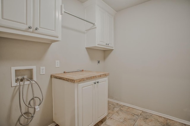 laundry room with hookup for a washing machine and cabinets