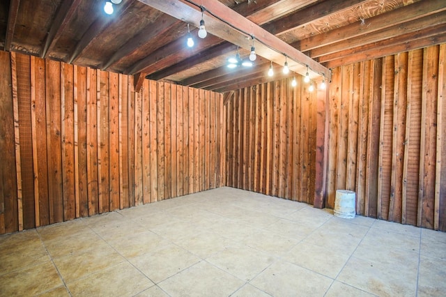 basement featuring wood walls