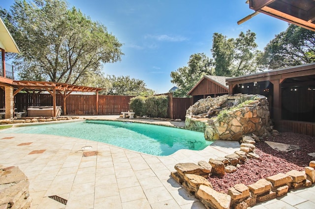 view of pool with a jacuzzi and a patio