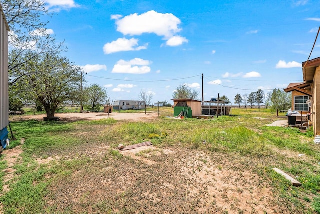 view of yard featuring an outbuilding and a storage unit