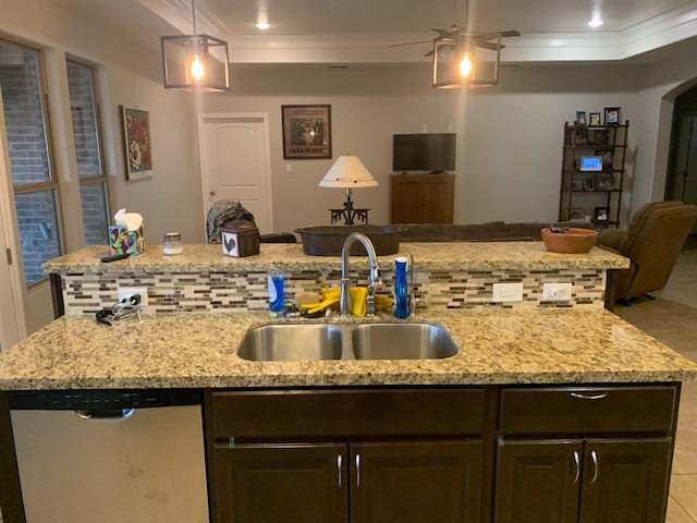 kitchen with sink, crown molding, dark brown cabinets, stainless steel dishwasher, and an island with sink