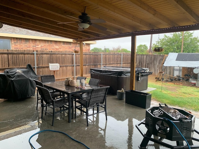 view of patio featuring ceiling fan, grilling area, and a hot tub