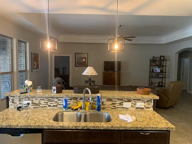 kitchen with pendant lighting, sink, crown molding, dishwasher, and a raised ceiling