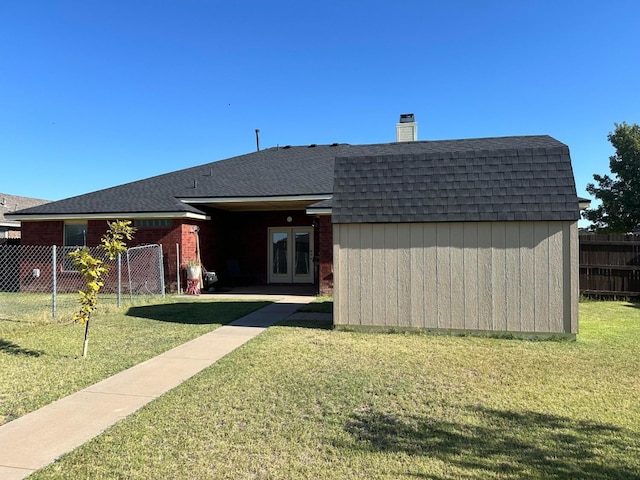 rear view of property featuring french doors and a yard