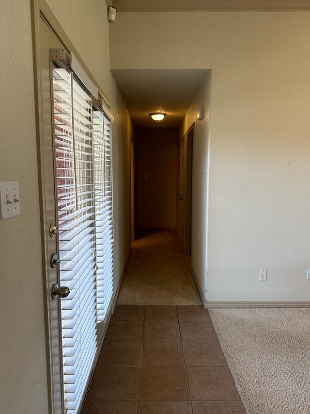 hallway featuring dark colored carpet