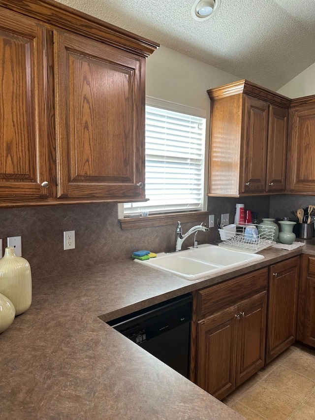 kitchen with sink, a textured ceiling, dishwasher, and backsplash