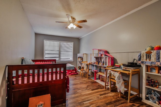 bedroom with crown molding, ceiling fan, wood-type flooring, and a textured ceiling