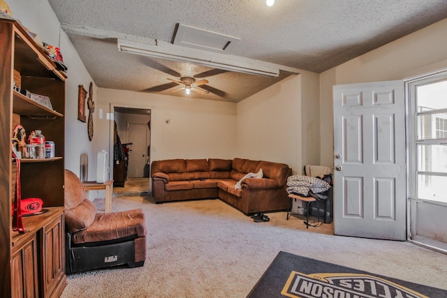 living room with ceiling fan, light colored carpet, vaulted ceiling, and a textured ceiling