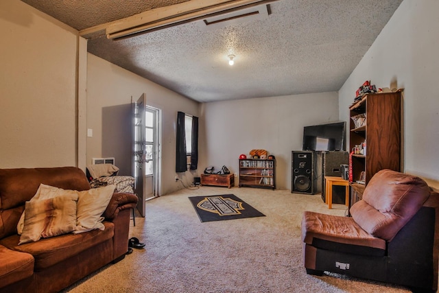 living room featuring carpet flooring and a textured ceiling