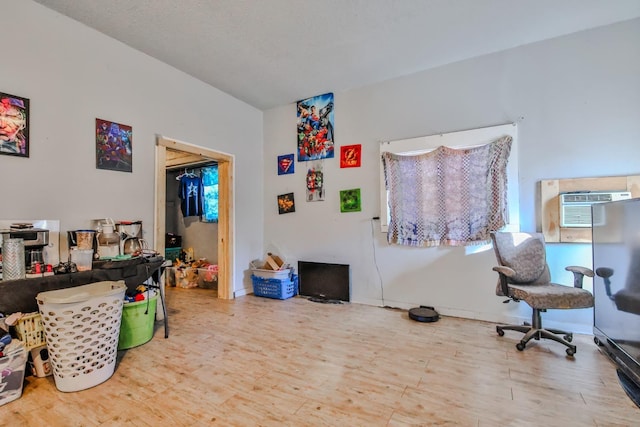 interior space with hardwood / wood-style flooring and a wall mounted AC