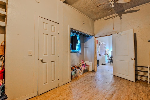 hallway featuring a textured ceiling and light wood-type flooring