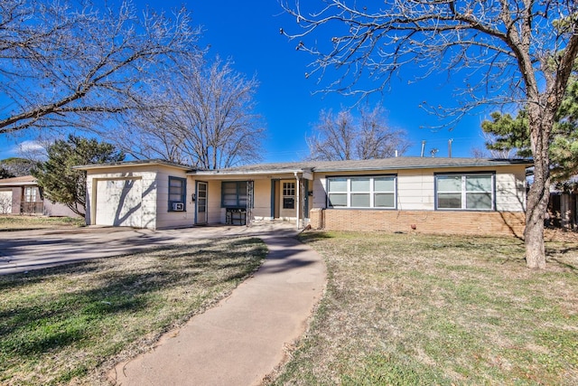 ranch-style home with a garage and a front yard