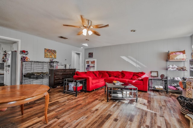 living room with hardwood / wood-style flooring and ceiling fan