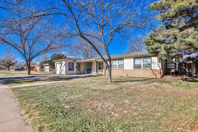 single story home featuring a garage and a front lawn