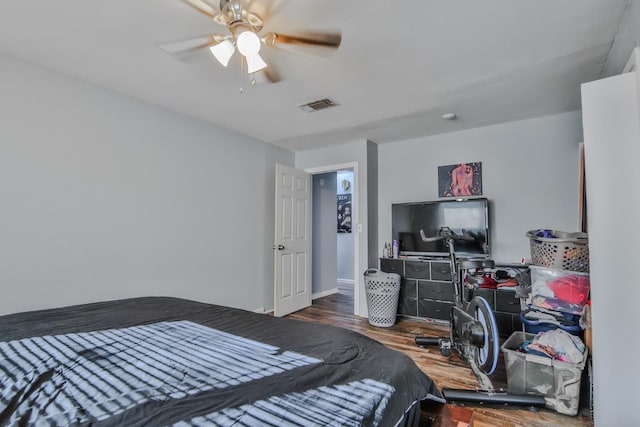 bedroom with wood-type flooring and ceiling fan