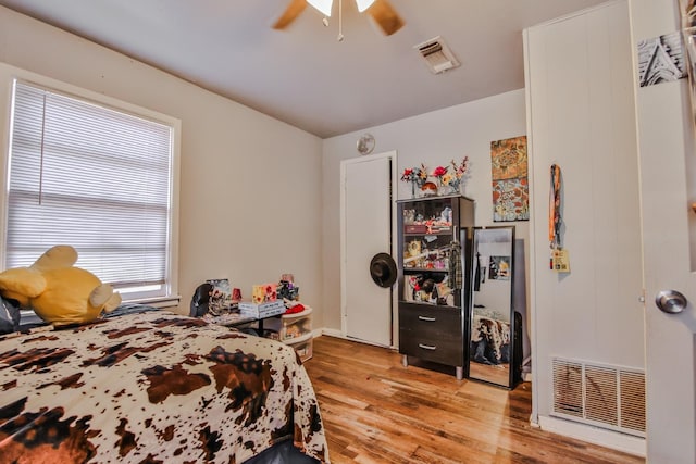 bedroom with ceiling fan and light hardwood / wood-style flooring