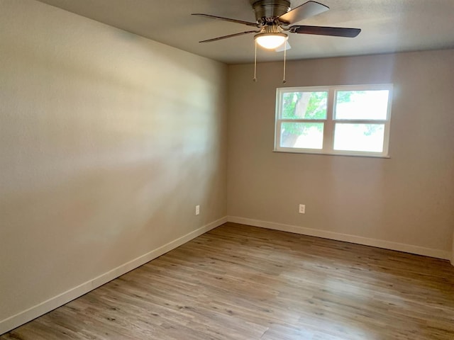 empty room with ceiling fan and light wood-type flooring