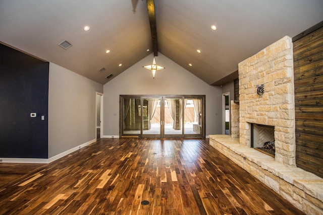 unfurnished living room with beam ceiling, a fireplace, visible vents, wood finished floors, and high vaulted ceiling