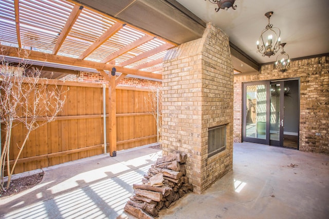 view of patio / terrace with an outdoor brick fireplace, fence, and a pergola