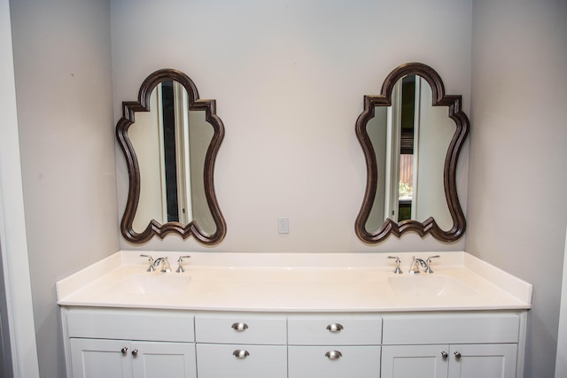 bathroom featuring a sink and double vanity