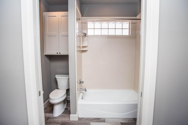 full bathroom featuring shower / bathtub combination, wood finished floors, toilet, and baseboards