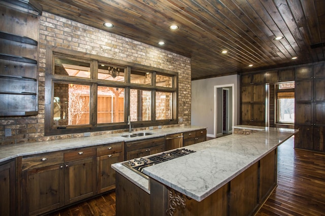 kitchen featuring wooden ceiling, a center island, light stone countertops, stainless steel appliances, and a sink