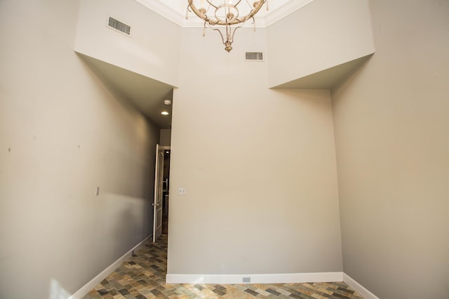 interior space with visible vents, baseboards, and an inviting chandelier