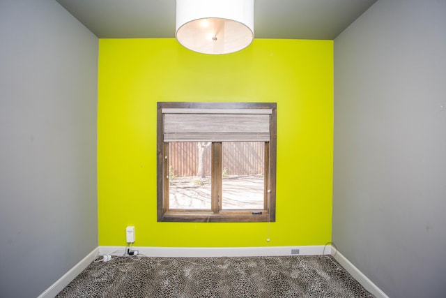 unfurnished room featuring baseboards