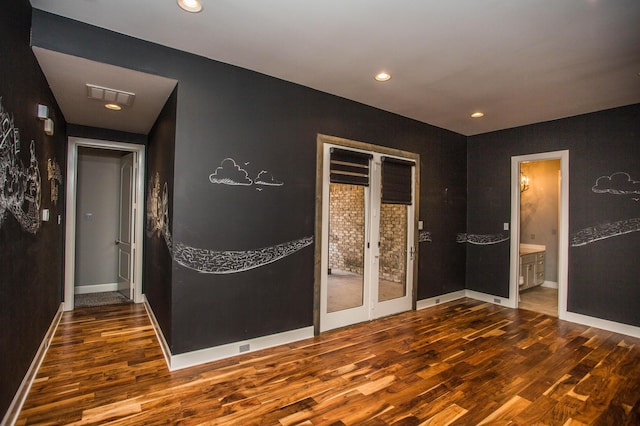 interior space with baseboards, visible vents, wood finished floors, french doors, and recessed lighting