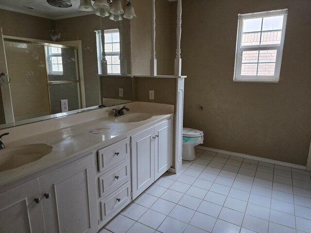 bathroom featuring toilet, tile patterned flooring, vanity, walk in shower, and crown molding