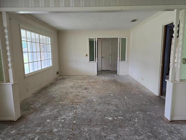 unfurnished room featuring crown molding and a textured ceiling