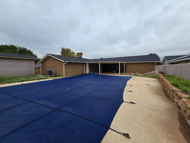 view of pool with a patio and central AC