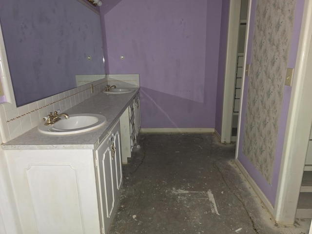 bathroom featuring vanity and backsplash